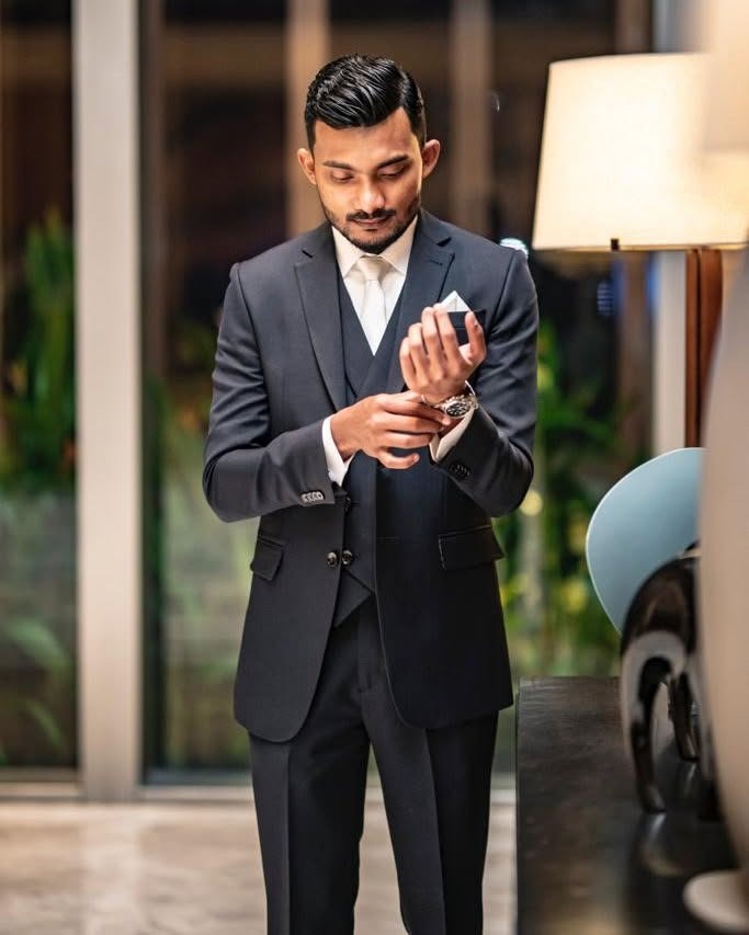 Man in tailored charcoal three-piece suit by RT Premium Suits